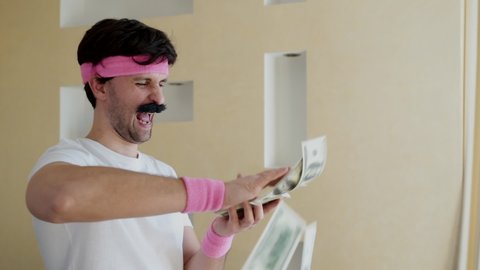Funny man with a mustache throws money
