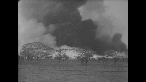 CIRCA 1937 - Smoke rises from the burning Hindenburg at the Naval Air Station in Lakehurst, New Jersey.