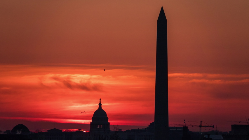 Timelapse of the the sun rising behind the Capitol Building and the Washington Monument in Washington DC as seen from the United States Marine Corps War Memorial in Arlington County, Virginia