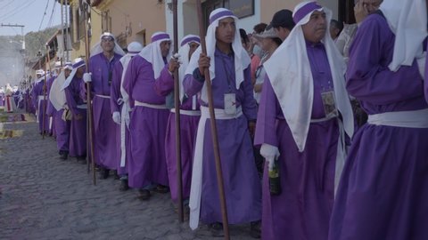 ANTIGUA, GUATEMAL - CIRCA 2010s - Purple robed Catholic Christian priests march in the Semana Santa Easter week holidays in Antigua, Guatemala.
