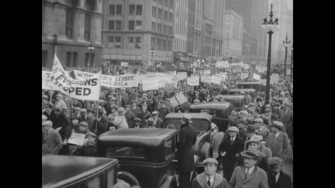 CIRCA 1932 - At a rally led by communist agitators in Chicago, Illinois, crowds protest the impending reduction of municipal support for the needy.