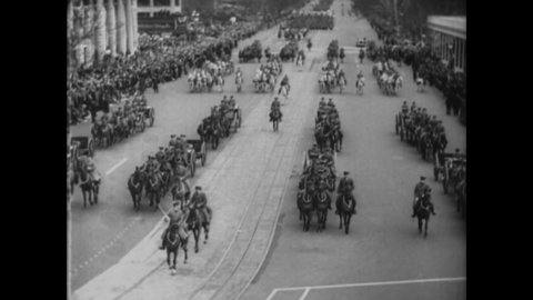 CIRCA 1933 - Crowds cheer as cavalrymen ride and American soldiers march down Pennsylvania Avenue in Washington DC for FDR's inauguration.