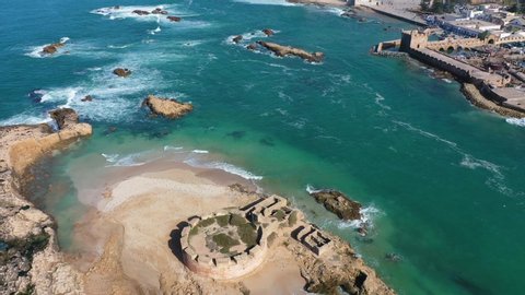 MOROCCO - CIRCA 2020 - nice aerial reveal of the city of Essaouira, Morocco and ruins on small island offshore.