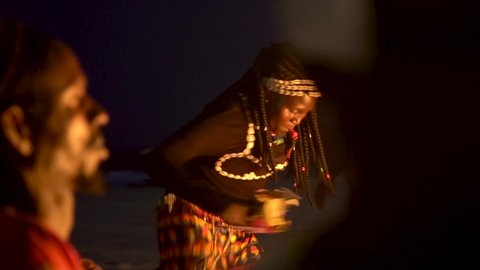 WEST AFRICA - CIRCA 2010s - African tribal dancers dance to drum rhythms in front of a bon fire in West Africa.