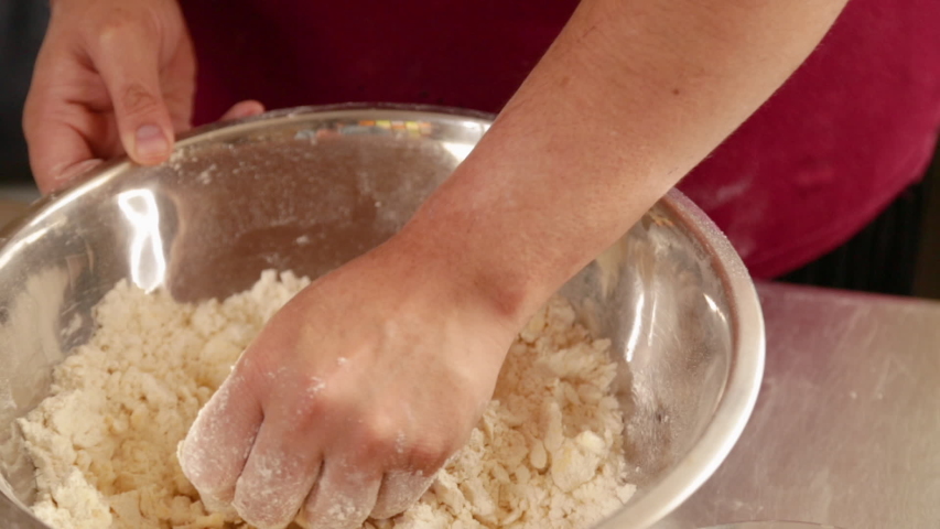 Woman mixing ingredients with her hands - mom making cookie mix at home - homemade pastry - close up | Shutterstock HD Video #1051456570
