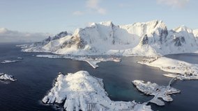 4K aerial - a bird's eye view video (Ultra High Definition) of Sakrisoy villege. Breathtaking winter view of Lofoten Island. Bright morning scene of Norway, Europe. Life over polar circle.