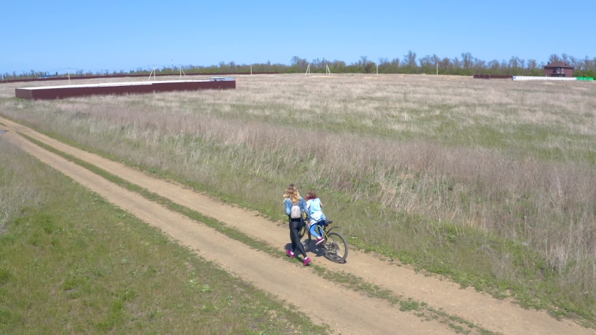 a girl rides a Bicycle in a field