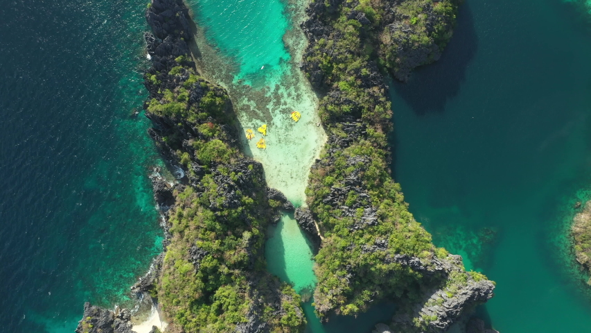 View from above, stunning aerial view of the Big Lagoon and the Small Lagoon, two beautiful bays of crystal clear water surrounded by rocky cliffs. Bacuit Bay, El Nido, Palawan, Philippines.