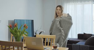 Young woman in pajamas with plaid dancing and listening to music at home. Weekend Family. Holidays time. Women's Day. 4K slow motion video.
