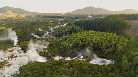 Wai-O-Tapu Aerial footage of hot sulphur springs at sunrise, showing colour splashed geothermal reserve of boiling water and steam evaporating in North Island of New Zealand