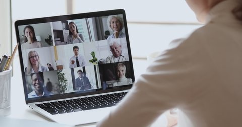 Video conference concept. Multiracial business team people communicate by web cam. Over shoulder view of distance employee at remote virtual online group meeting by video call working from home office