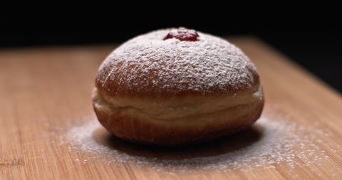 Close up of hanukkah doughnut covered in sugar powder, slow motion, BMPCC 4K