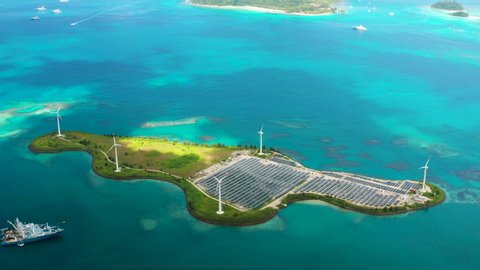 Aerial footage of solar farm on Romainville Island at Seychelles with wind turbines.