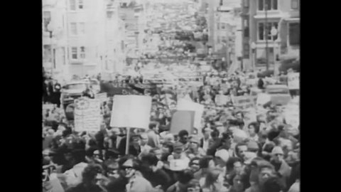 CIRCA 1967 - Anti-war protestors march down Market Street in San Francisco, California, towards a rally held in Kezar Stadium.