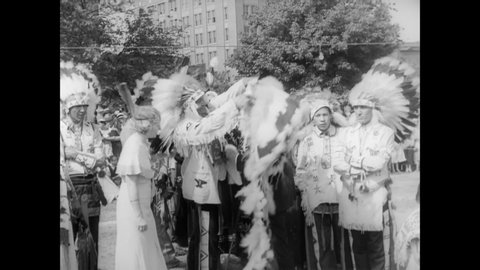 CIRCA 1934 - Native Americans of Wyandotte County in Kansas give a war bonnet to Governor Landon, and participate in traditional dances.