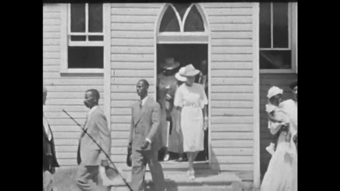 CIRCA 1920s - African-American congregants are seen going to church, and children sing in the choir.