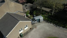 4K: Aerial Drone Shot - Grocery delivery driver from Supermarket lifts a crate of food out of the van - He is wearing a face mask.Stock Video Clip Footage - Powered by Shutterstock - Get 15% off with code: PIKWIZARD15