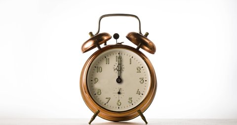 clock hand spinning on vintage alarm clock on white background,  Ventage watch timelapse. 
