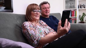 middle-aged caucasian couple makes video call from home