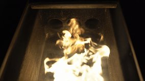 Close-up of flames inside the pellet stove, alternative biofuel burning in stove for heating houses. Ecological and economical biomass used for warming. Ecology concept