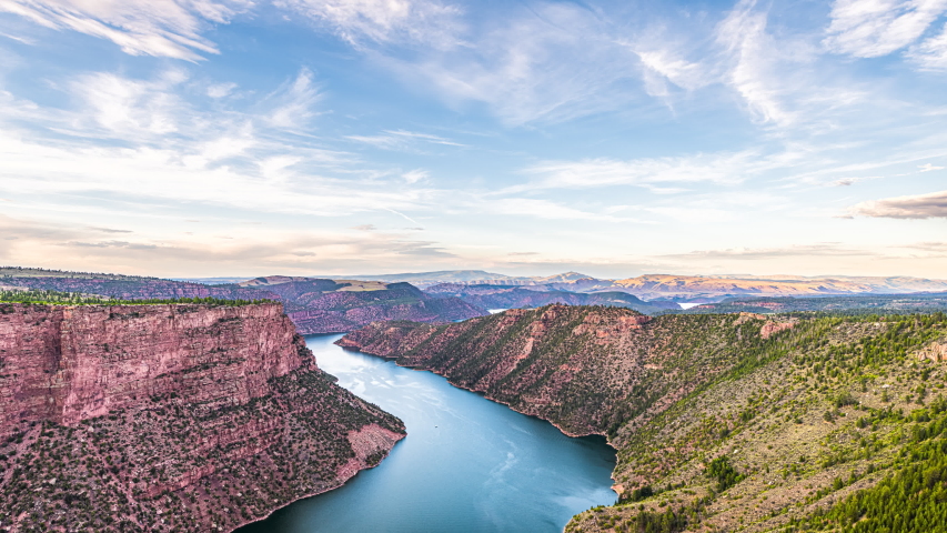 Aerial above view timelapse from Canyon Rim trail overlook near campground in Flaming Gorge Utah National Park with Green River at sunset