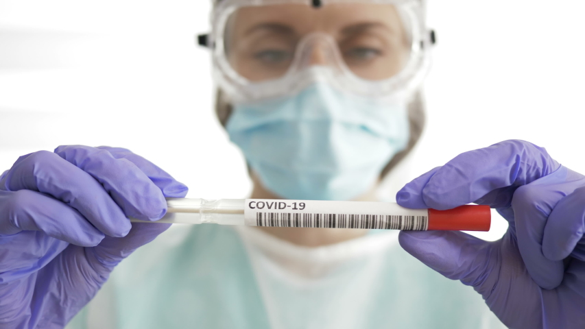 Medical worker holding Coronavirus COVID-19 NP OP swab sample test kit, nasal collection equipment. Result is positive. Royalty-Free Stock Footage #1051522234