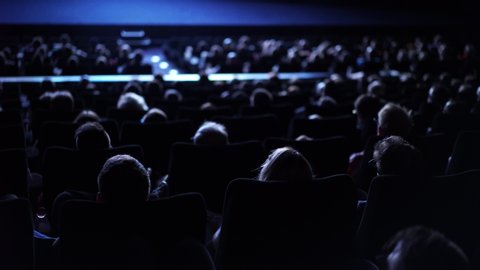 Large crowd of people during a film performance - cinema
