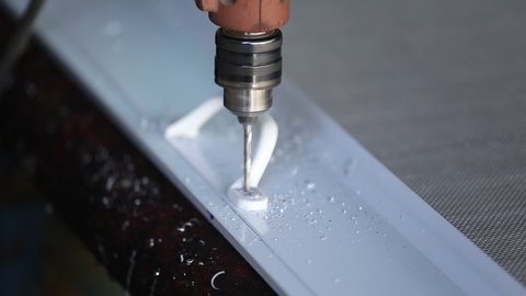 Mechanic is drilling aluminum by using a small drill to drill aluminum