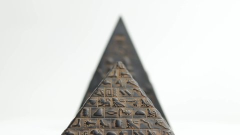 pyramid figurine. figurine pyramid on a white background. the pyramid is spinning

