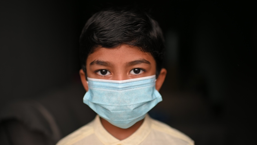 Asian Boy Wearing Masks looking at camera to Prevent Disease and Dust, pm.5,Stay at home quarantine coronavirus pandemic prevention. Footage in some noice  and film grain effect.