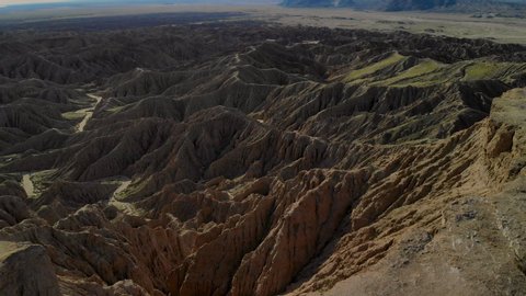 Cinematic aerial flyover of badlands at Font's Point in Anza Borrego Desert State Park in Southern California