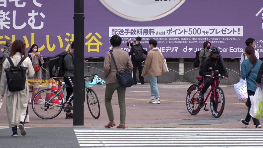 Tokyo, japan - april 2020 : uber eats food delivery at the street. uber  eats is an american onlineu2005foodu2005ordering and delivery platform launched by  uber.