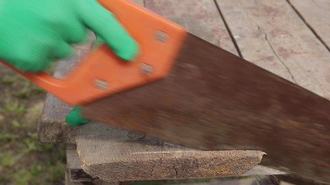 Hand saw on wood. Hacksaw. Wood sawing with a hacksaw. Close-up

