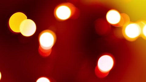 Deep red colored bokeh abstract background. Filmed with real lens and colored. Great for Christmas overlay or background.