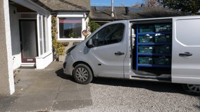 4K: Grocery delivery driver from Supermarket lifts a crate of food out of the van - Online order. Stock Video Clip Footage