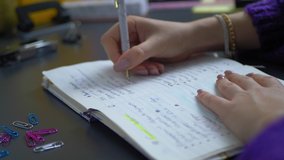 Female hands writing notes on a desk. Slow motion, journal, woman writes in notebook bussines
