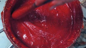 red froth pours out of the pan. making berry syrup. - Powered by Shutterstock - Get 15% off with code: PIKWIZARD15