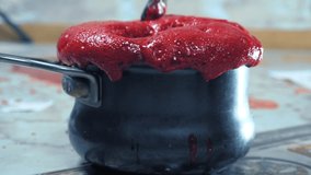 red froth pours out of the pan. making berry syrup. - Powered by Shutterstock - Get 15% off with code: PIKWIZARD15