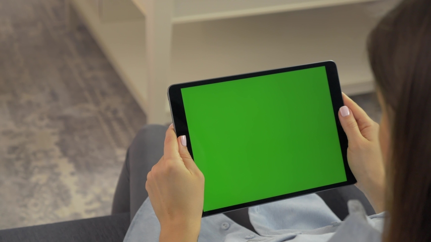 woman holding green screen ipad in hands is sliding camera Royalty-Free Stock Footage #1051573390