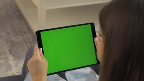 woman holding green screen ipad in hands is sliding camera - Powered by Shutterstock - Get 15% off with code: PIKWIZARD15