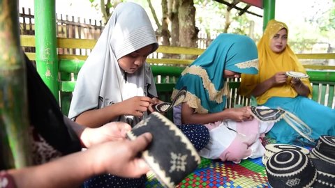 Aceh/Indonesia- October 08 2019. The process of making Kupiah Riman souvenirs typical from Aceh origin Pidie. The kupiah is a kind of head covering originating from Pidie district, Aceh, Indonesia.