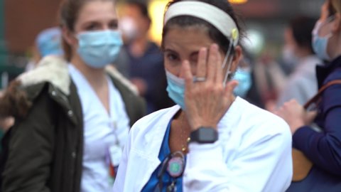 New York City, New York / USA - May 1 2020: New York hospital healthcare workers and nurses clapping expressing gratitude for saving lives during pandemic coronavirus outbreak in New York City, 7pm