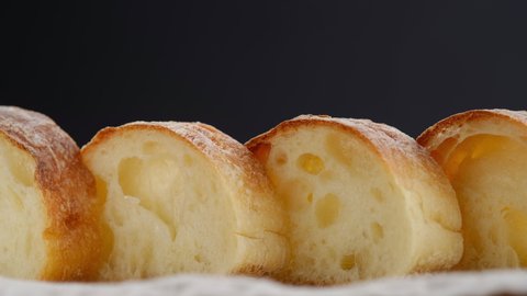 rotation sliced italian tradition bread ciabatta. closeup black background