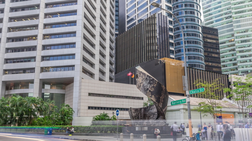 Singapore Raffles Place in the Central Business District Singapore timelapse hyperlapse, Singapore. Monument and skyscrapers on a background