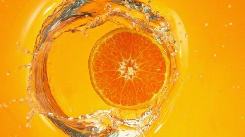 Super Slow Motion Shot of Orange Slice on Orange Gradient Background Splashing to Water at 1000fps.