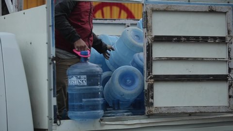 Kathmandu, Nepal - 22 November 2019: Indian men delivering water cooler in a truck. India.