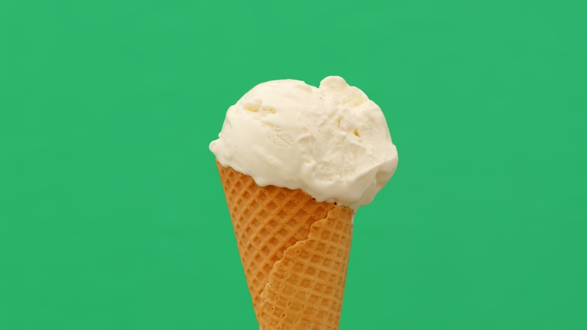 Time lapse of melting ice cream cone on green background, 4K Royalty-Free Stock Footage #1051619809