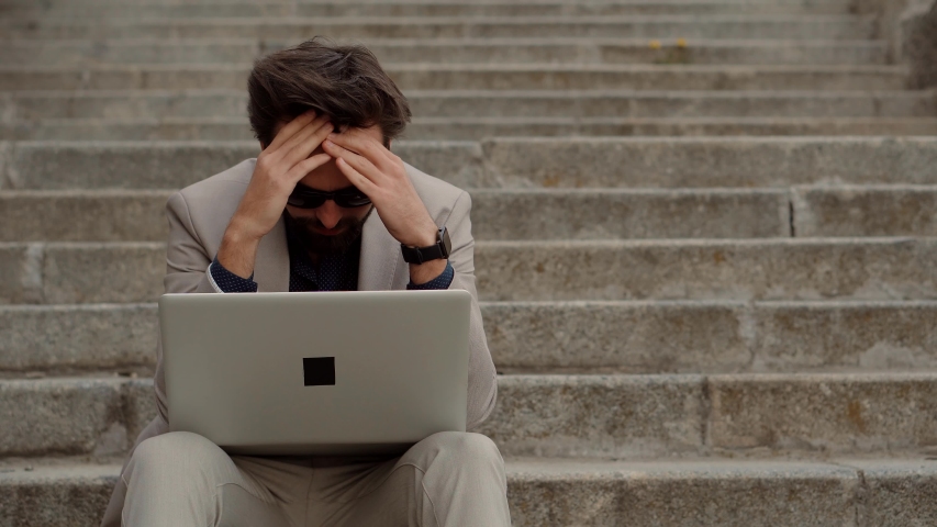Frustrated Businessman Sitting On Steps.Remote Work Overtime.Workaholic Work In Internet Deadline. Tired Businessman In City Street.Overwhelmed Exhausted Stressed Man.Tired Worker Overworked On Laptop | Shutterstock HD Video #1051624816
