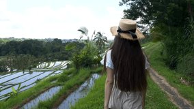 Young Female walking on rice field terrace