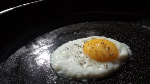 Fried egg sprinkled with pepper